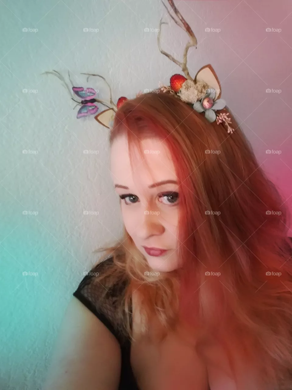 Fairy cosplay. woman with red hair and antlers cosplaying a forest spirit.