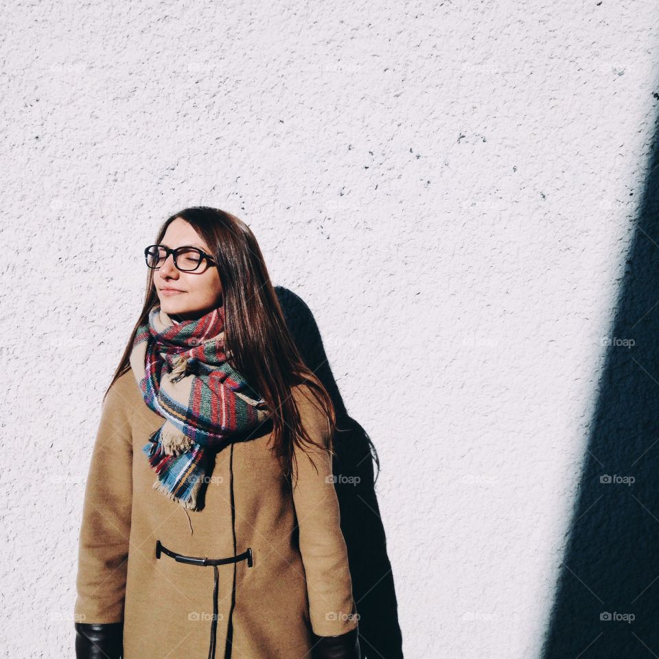 Woman posing in front of wall