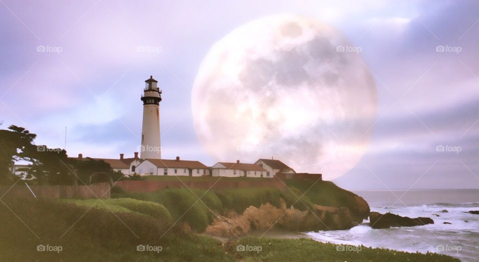 Lighthouse against sky with moon