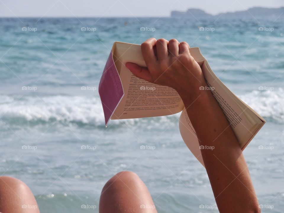 reading and relaxing with a book at the sea