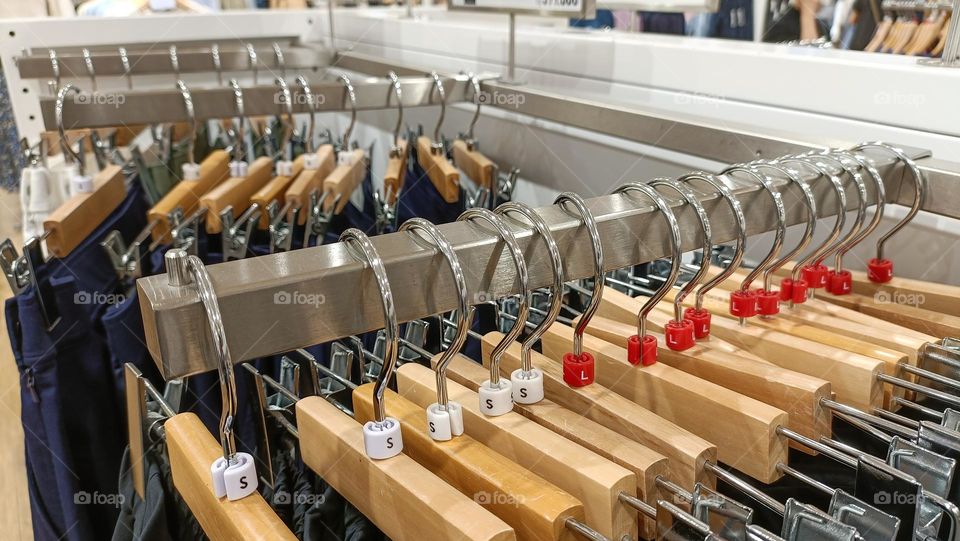 top view of hanging clothes arranged on a display rack.