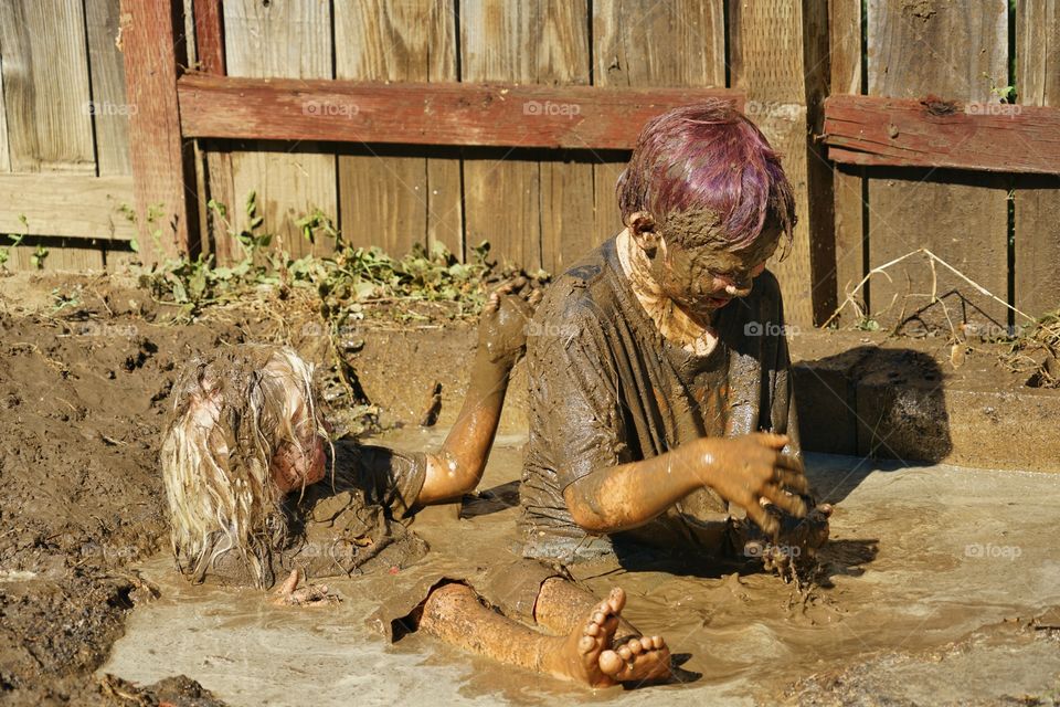 Kids Playing In Mud