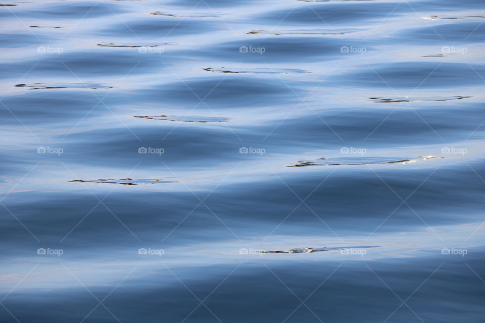 Ocean , close-up .. beautiful blue , calm with motion waves and ripples. Nature in serenity..