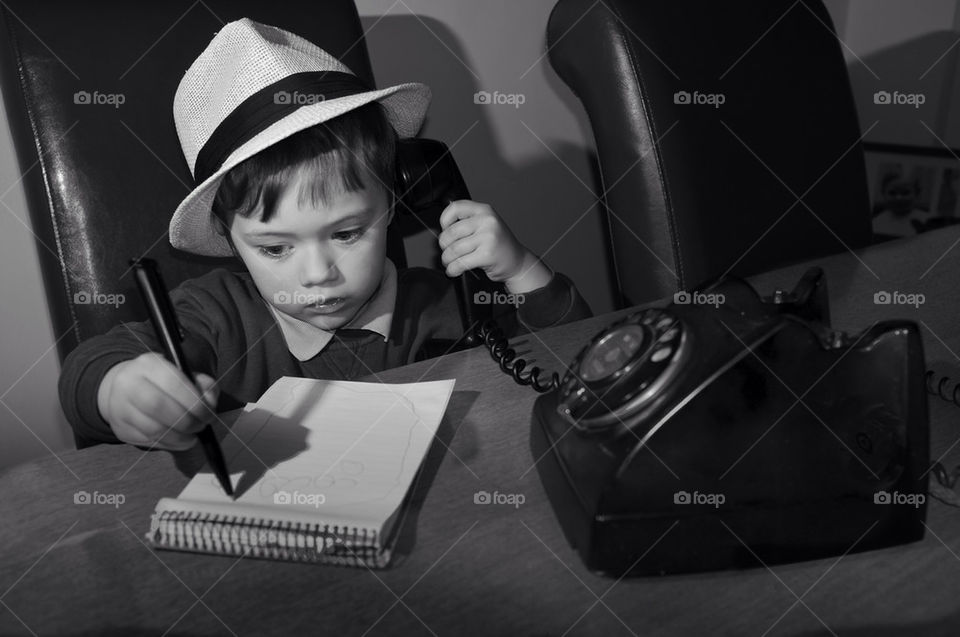 Black and white, noir style image of a white boy, aged 3 wearing a