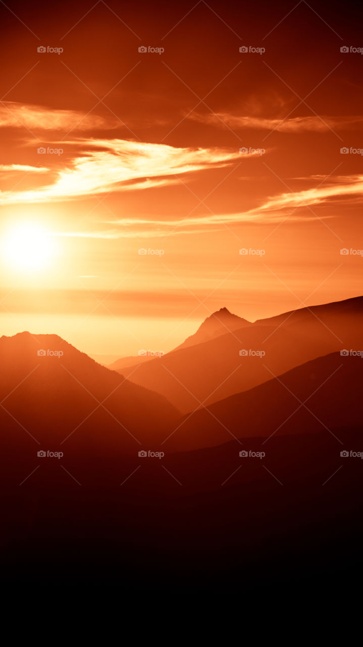 An inspiring red mountain landscape. Tatry mountains in Slovakia. A beautiful wallpaper for smartphone screen. Red abstract gradient with perspective.