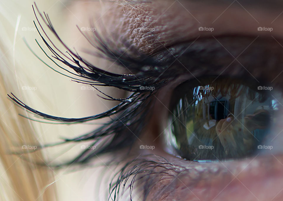 Close-up of bride's eye looking at her engagement ring