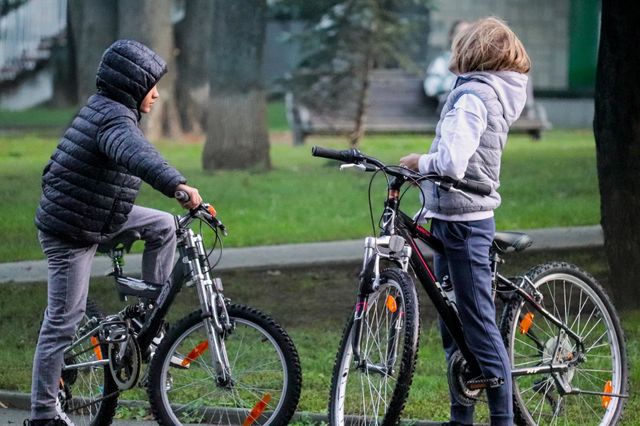 Boys riding a bicycles