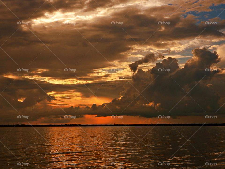 Dramatic sunset was so magnificent that even the sun itself watches it every day in the reflection of the infinite bay