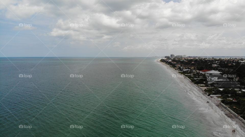 Florida clear blue water birds eye view - Floridian sandy beaches drone. city ​​on the beach Aerial view of Indian Rocks Beach. beautiful clear water, beach houses
