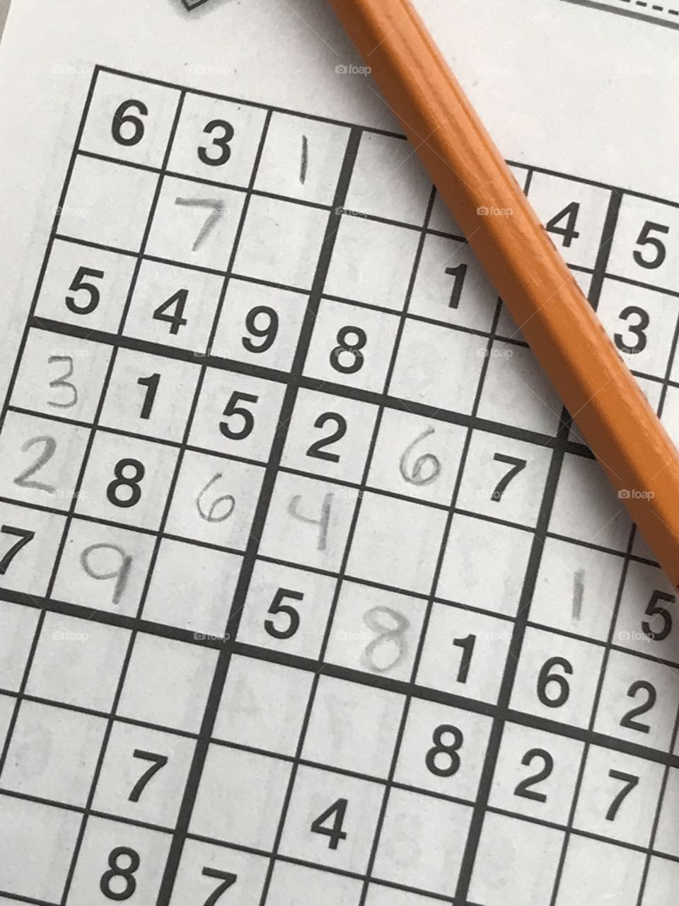 Closeup of sudoku page and pencil