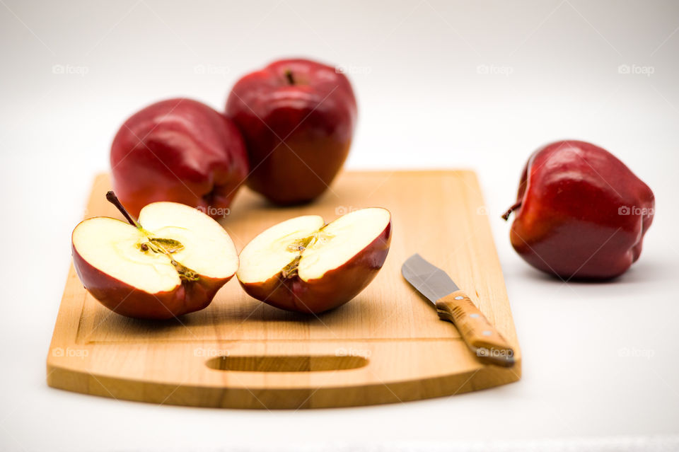 Red apples on cutting wooden board