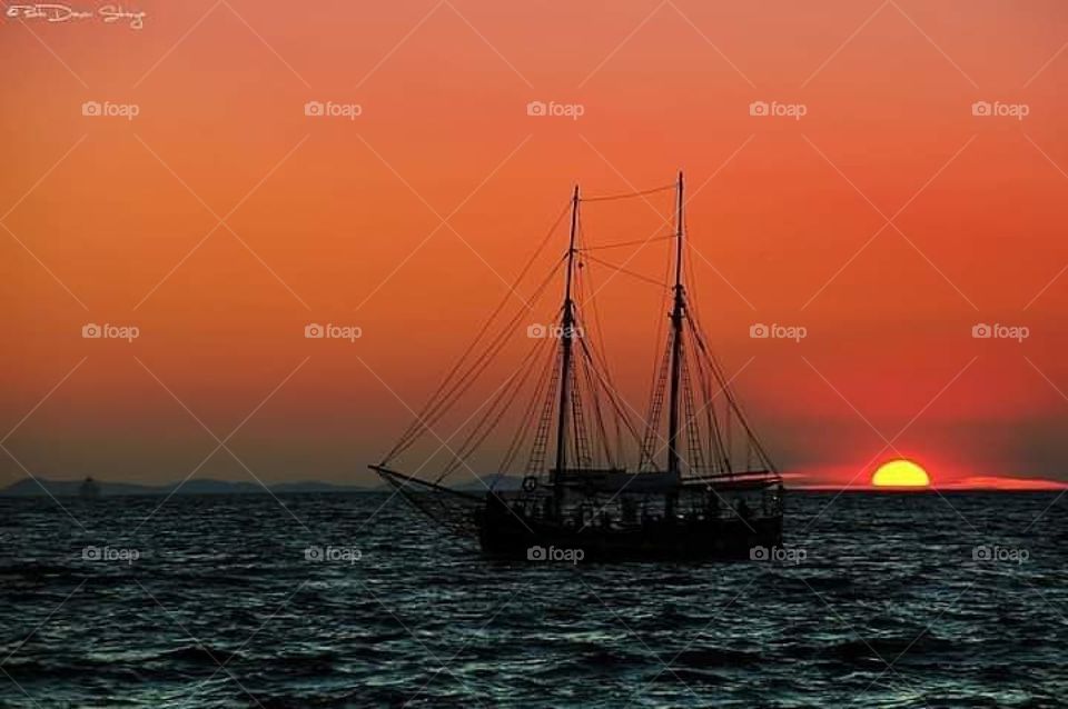 Zadar city in Croatia the sun goes down at dusk boat sails.