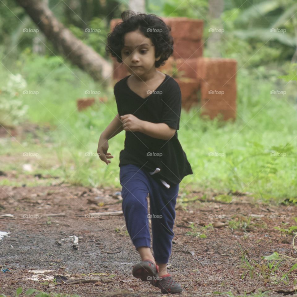 Little boy running while playing. 