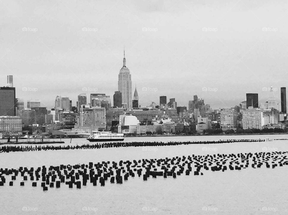 New York City skyline taken from a park in Jersey City, NJ by my girlfriend. This black and white shot of Manhattan shows the Empire State Building as the focal point of this excellent NYC skyline photo. Still the most amazing cityscape in the world to me. Here you can see boats coming through the Hudson River.

I 💓 NY
NEVER FORGET 9/11...
R.I.P. to those that were lost