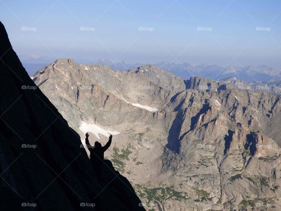 silhouette of a man climbing a mountain in the Colorado Rockies