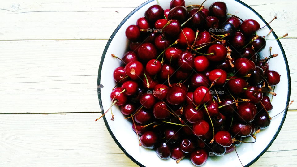 cherry in a bowl on a white background