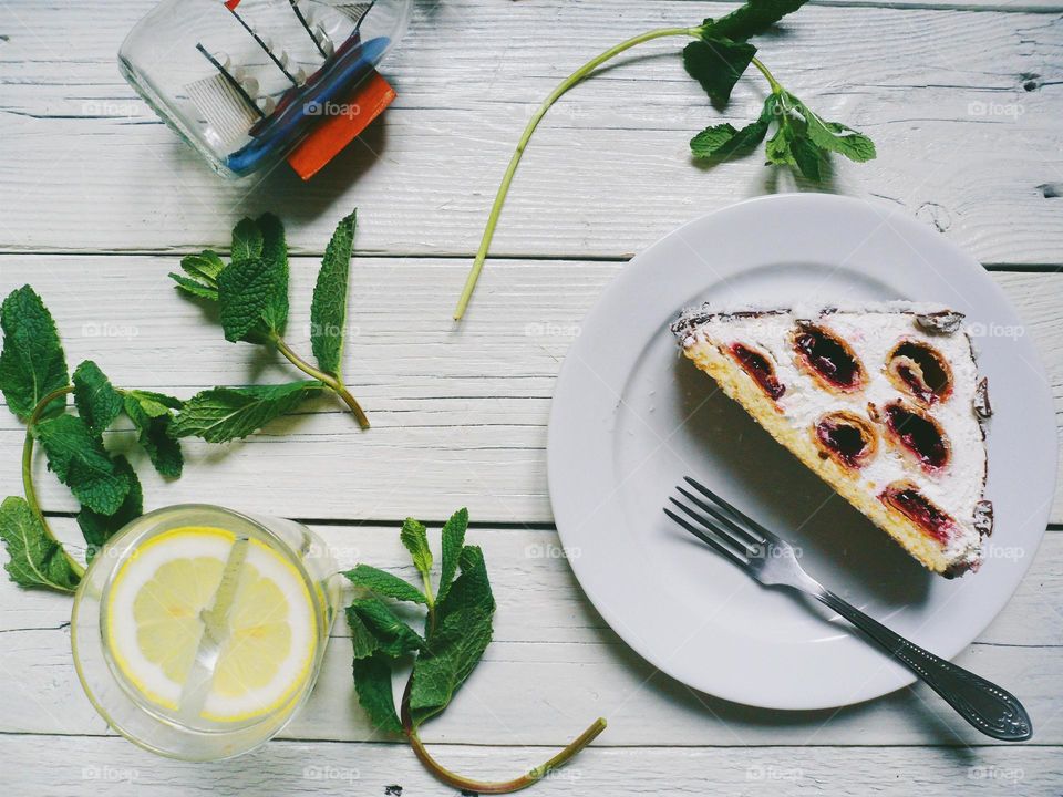 cake, lemonade in a glass and mint leaves