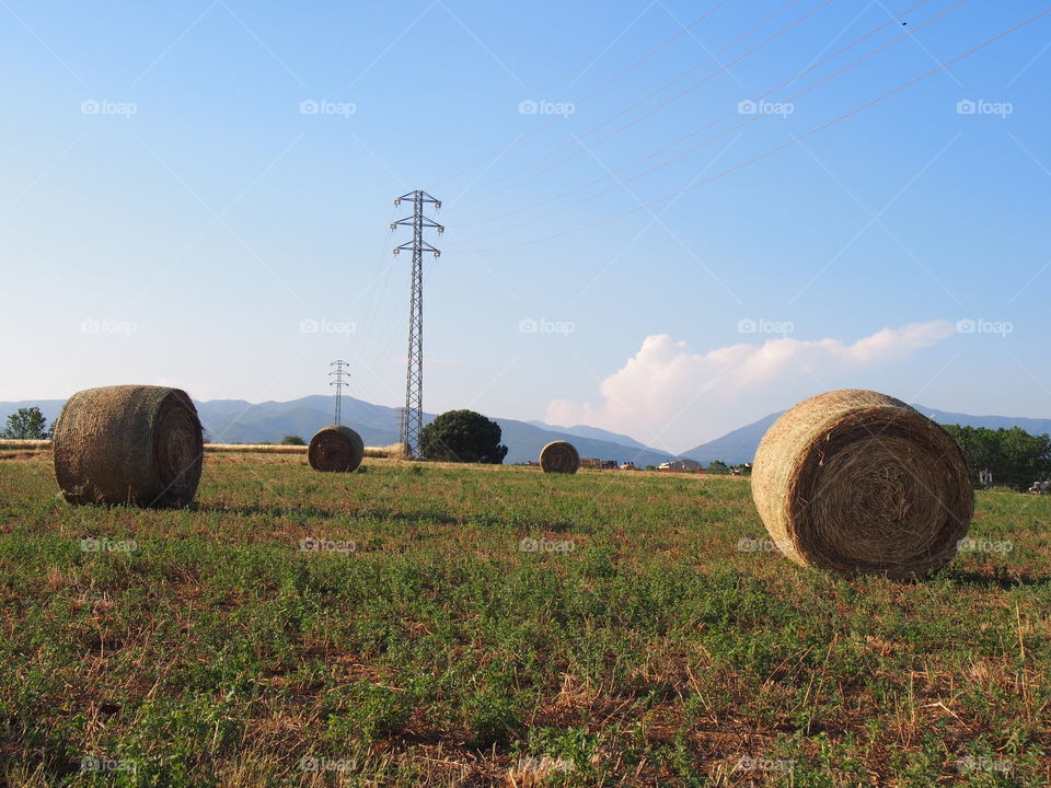 countryside  landscape with mountains straw and electrical towers