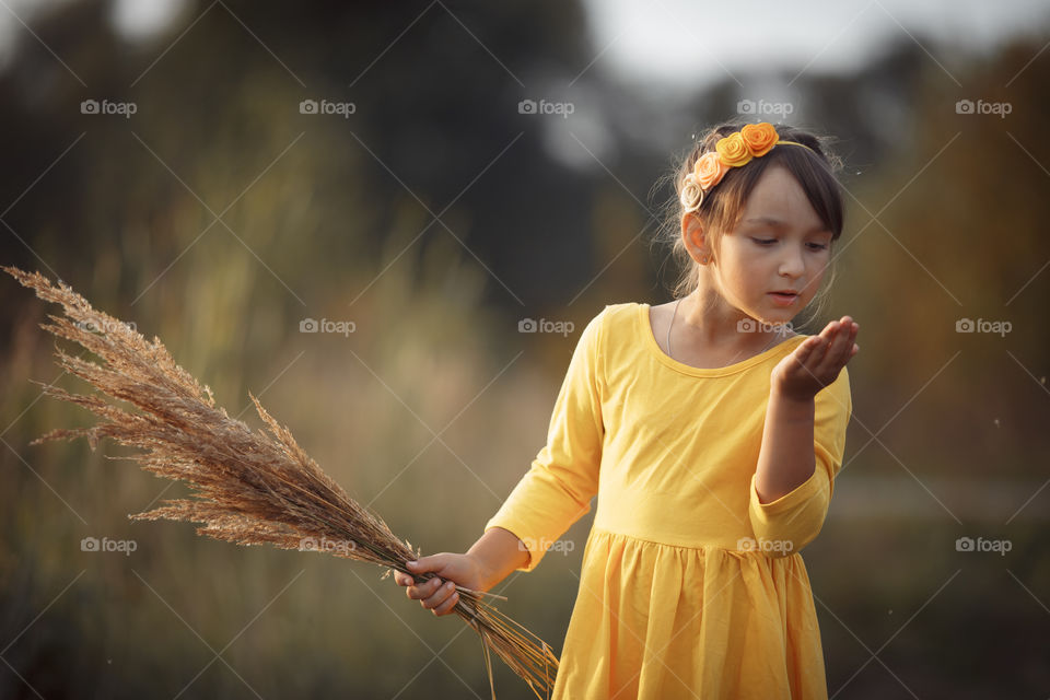 Little girl in yellow dress outdoor portrait 