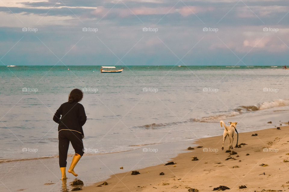 connection between dog is owner enjoying the red crown beach Bahia Brazil