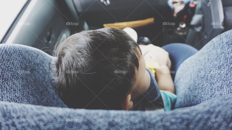 Little boy is sitting in car seat