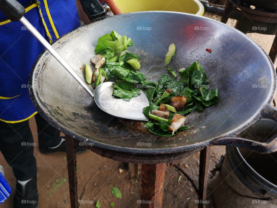 Chef is Cooking the Crispy pork with Chinese broccoli and oyster sauce.