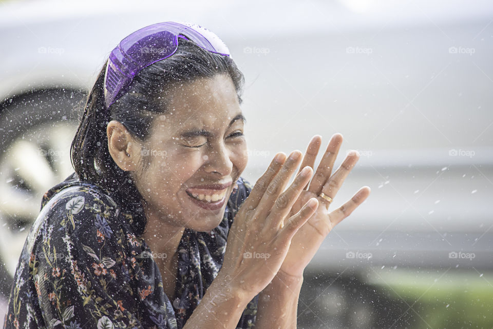 Asian woman play water in Songkran festival or Thai new year in Thailand.