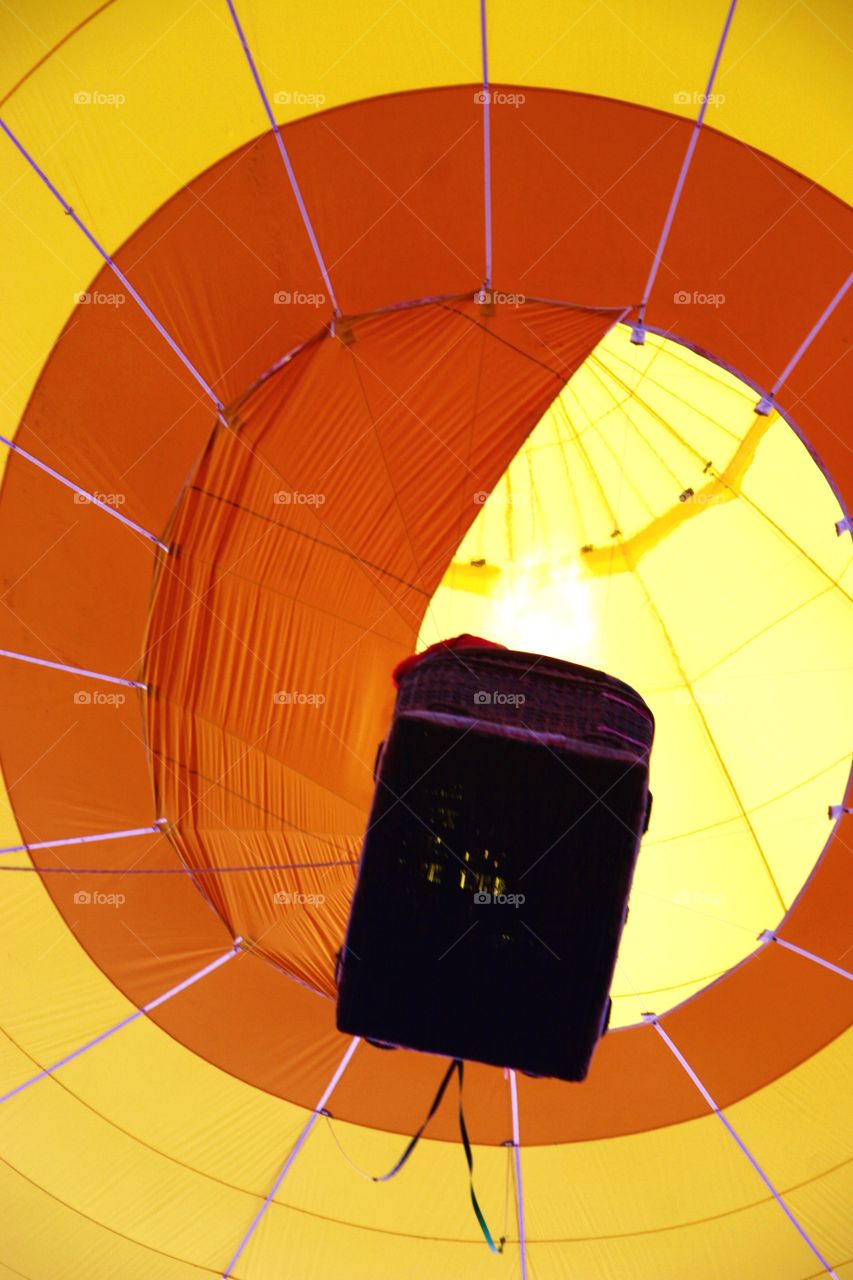 Yellow hot air balloon. Yellow hot air balloon from below with basket