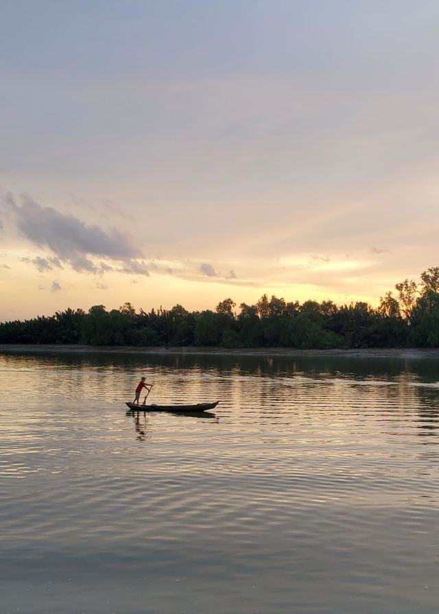 The man rowing boat in the sunset