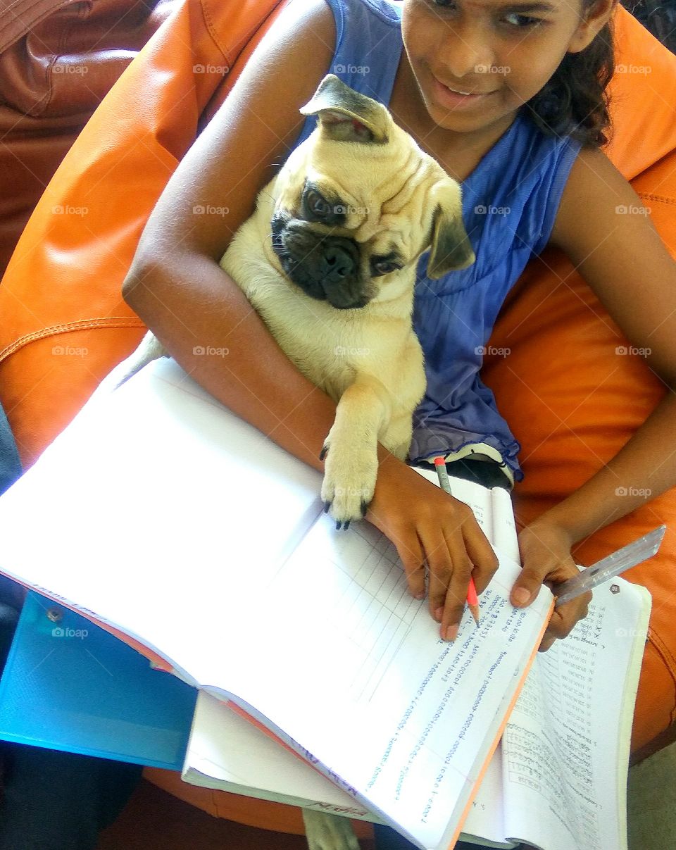 A girl writing note with her pet