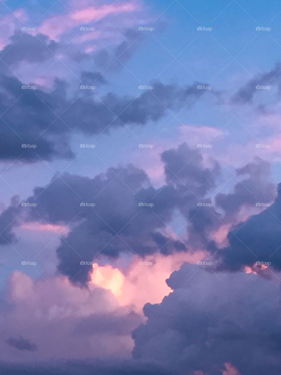 A blue sky with lavender and pink clouds