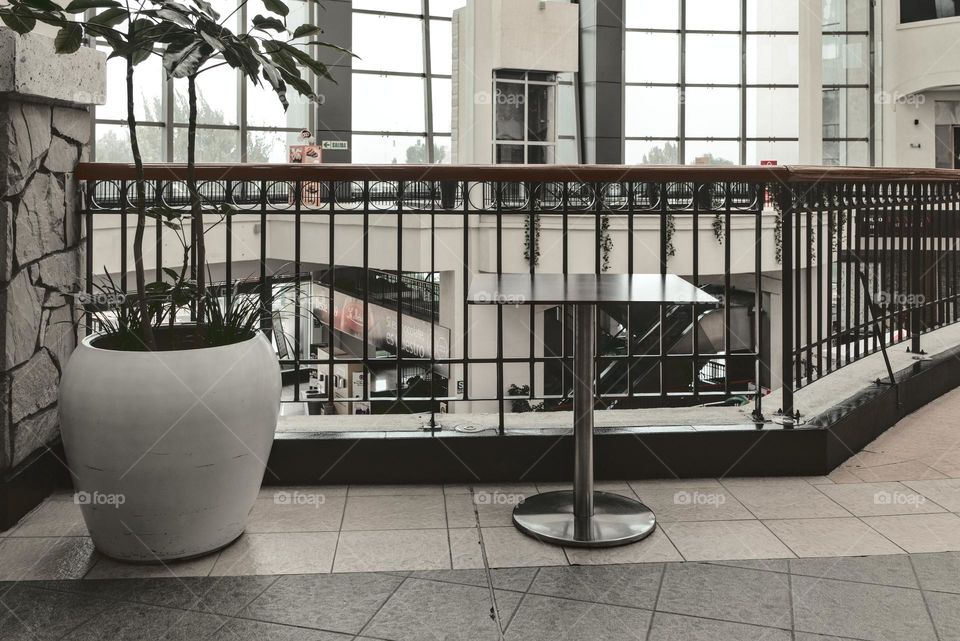 Floral decoration and table inside a shopping mall. Interior of a shopping mall