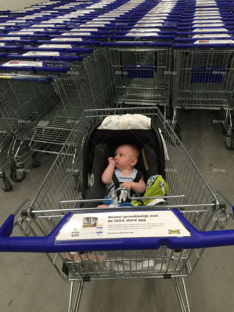 Cute baby sitting on trolley