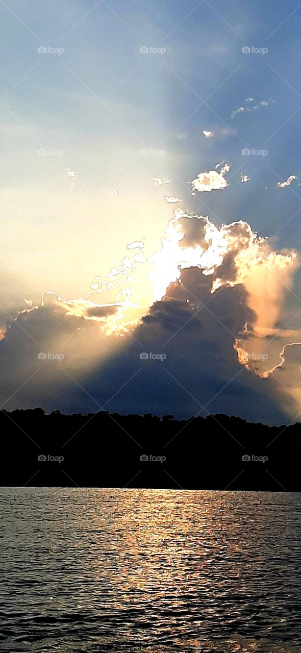 sunset explodes through the storm cloud