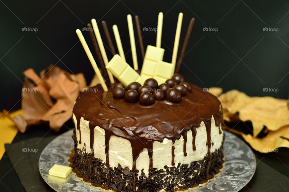delicious drip cake with various types of chocolate: dark, white and milk