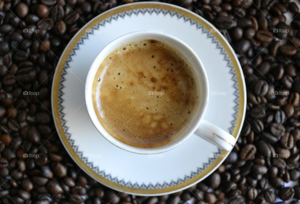 Cup of coffee with coffee beans