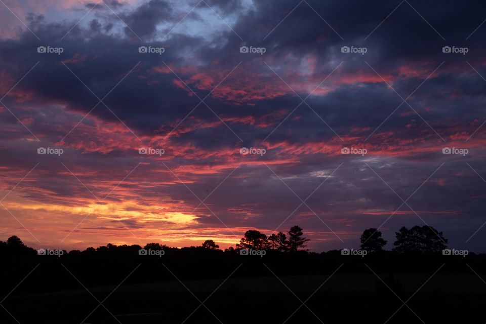 Dramatic clouds remain as a storm departs during sunrise in Raleigh North Carolina. 