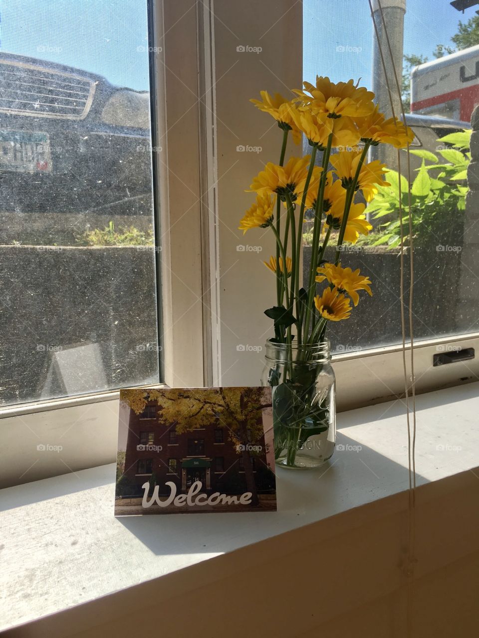 Flowers and a welcome to the neighborhood card