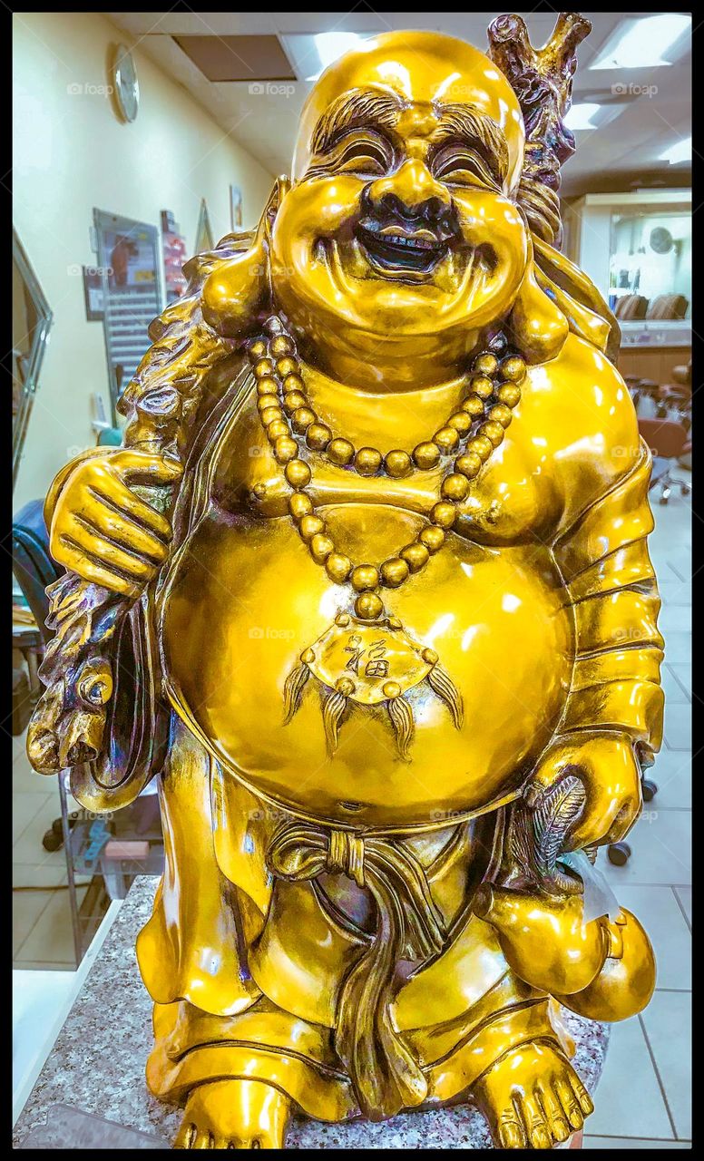 A Laughing Buddha emitting positive energy in a place of business. He attracts good fortune and abundance.