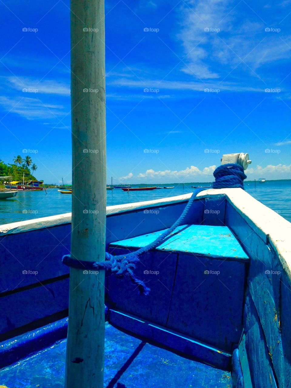 a blue boat on the beach of Catu, Itaparica island, Bahia, Brazil