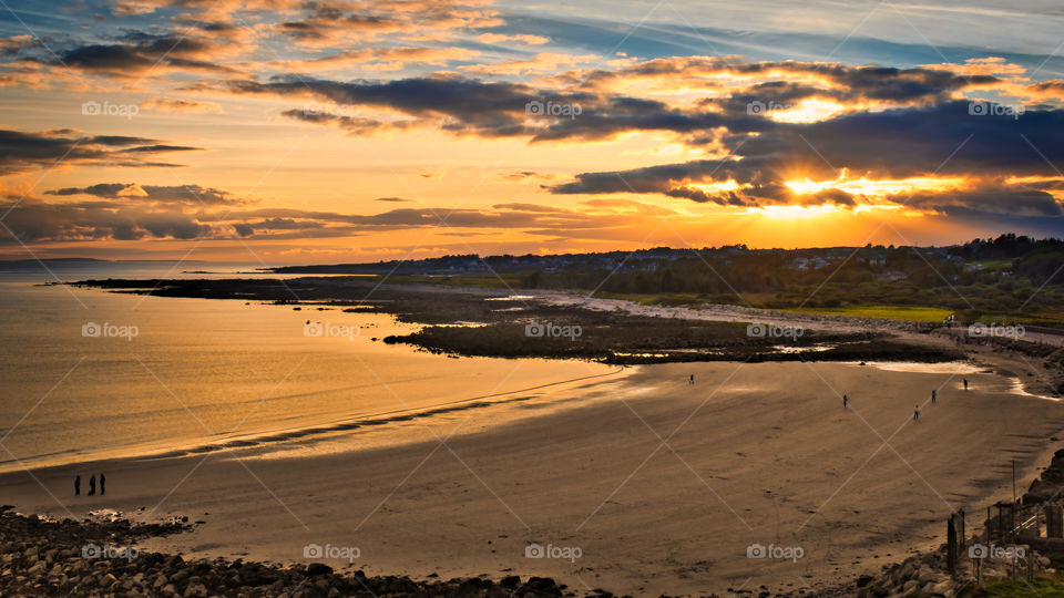 Beautiful golden sunset at Silverstrand beach in Galway, Ireland