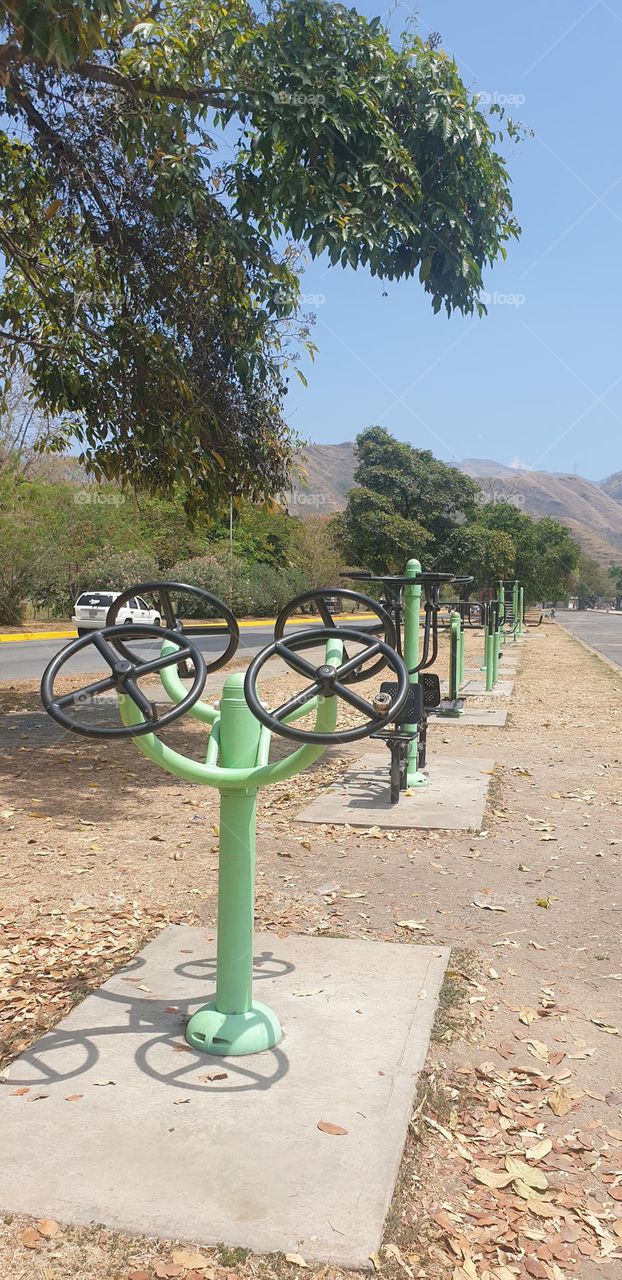 outdoor exercise station, wheels, weights, round, circles