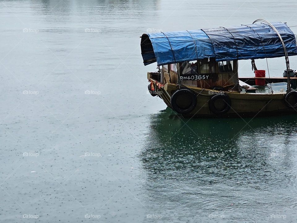 Walla walla boat parked at the typhoon shelter on a rainy day