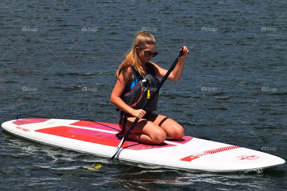 Young woman on a paddle board 