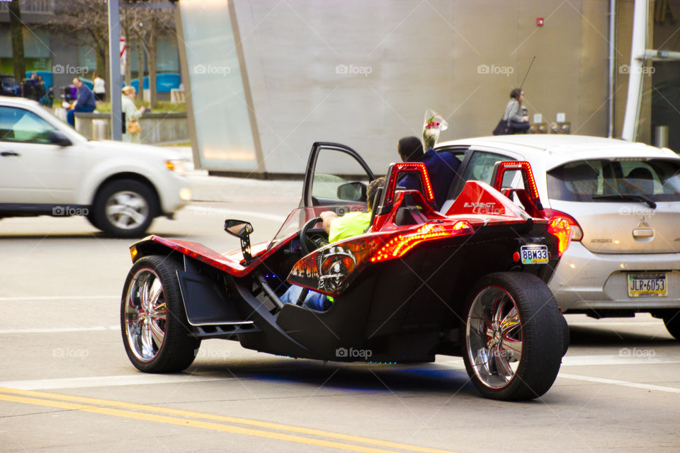 Trendy vehicles on road, red wheels,crazy cars