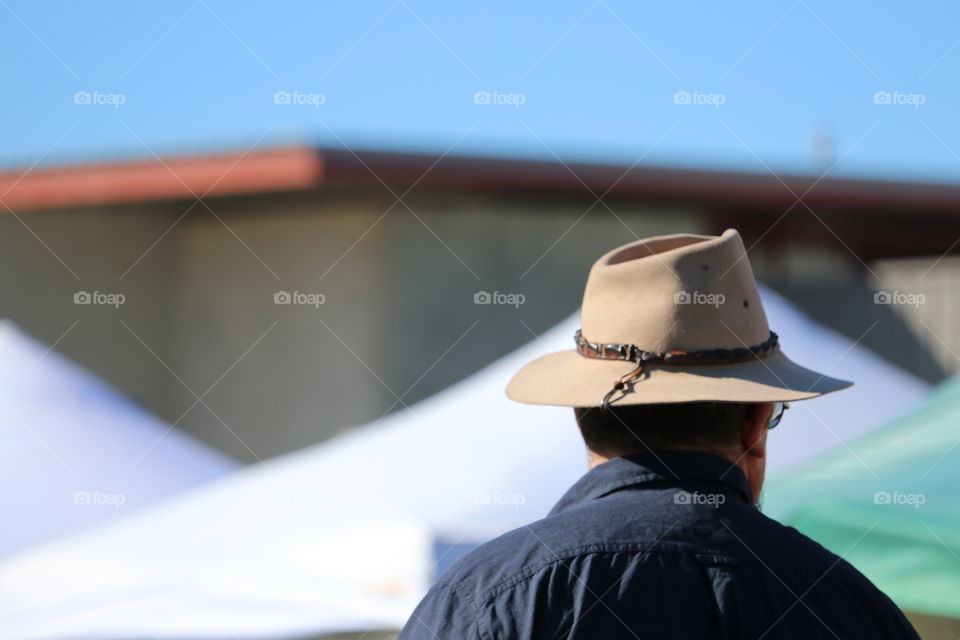 Back view head shot man wearing felt hat outdoors