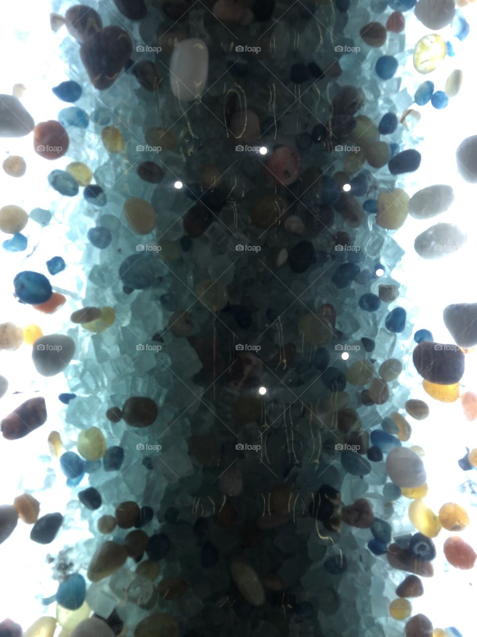 Colourful small crystal stones with light coming across 