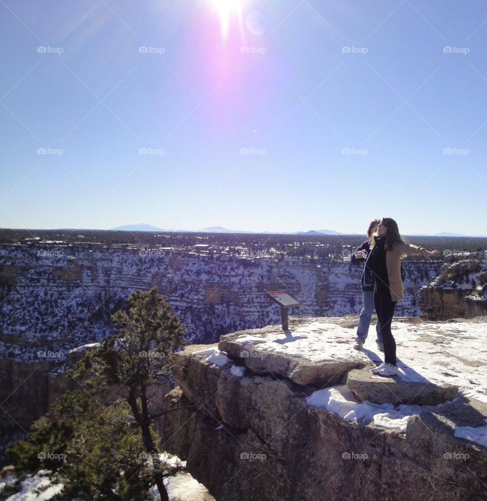 Girl on cliffs edge at Grand Canyon 