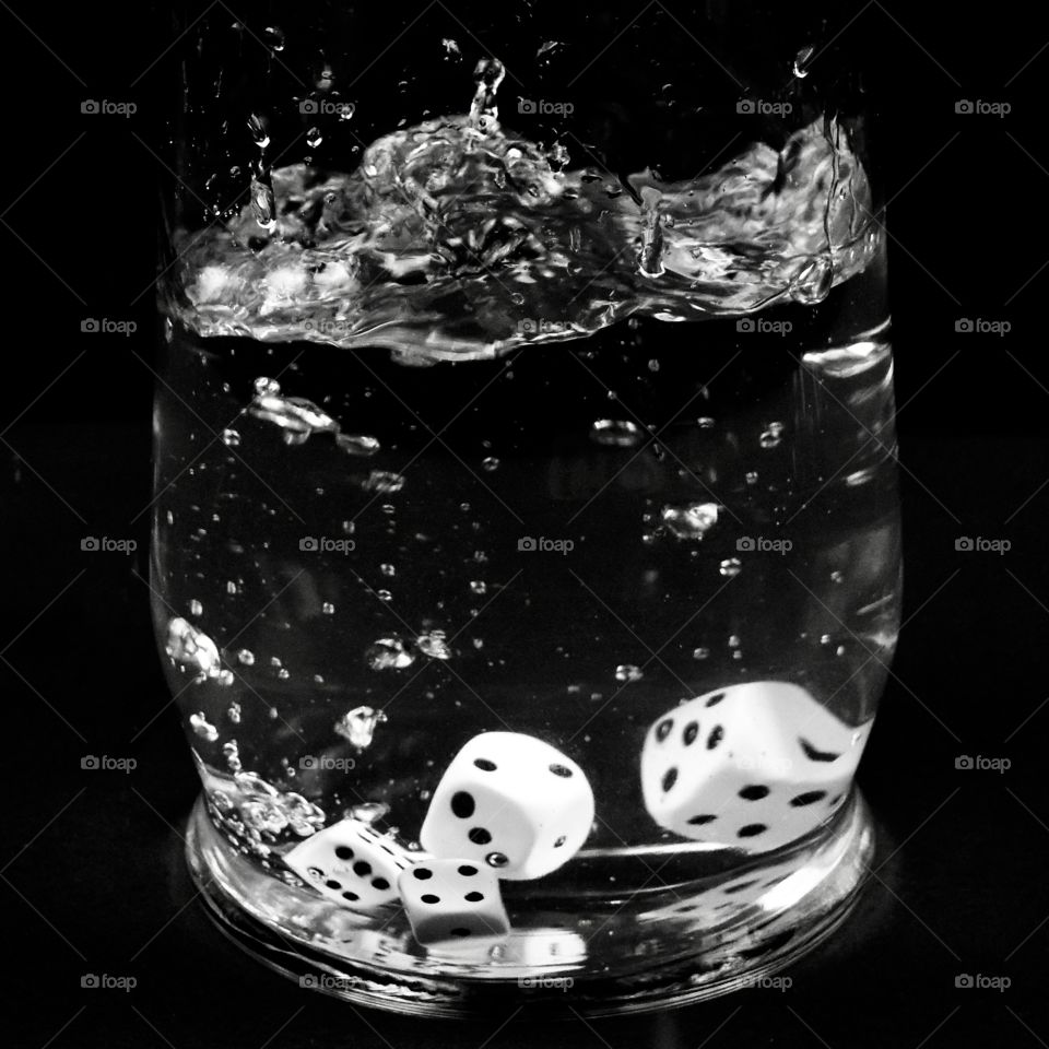 Dice splash in water with black background 