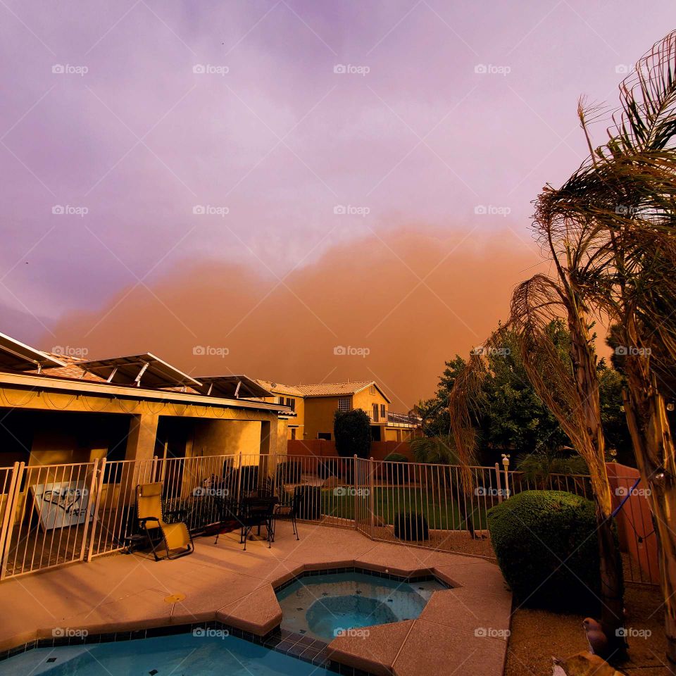 A duststorm in Arizona casts an eerie glow as it makes it's way into a residential neighborhood.